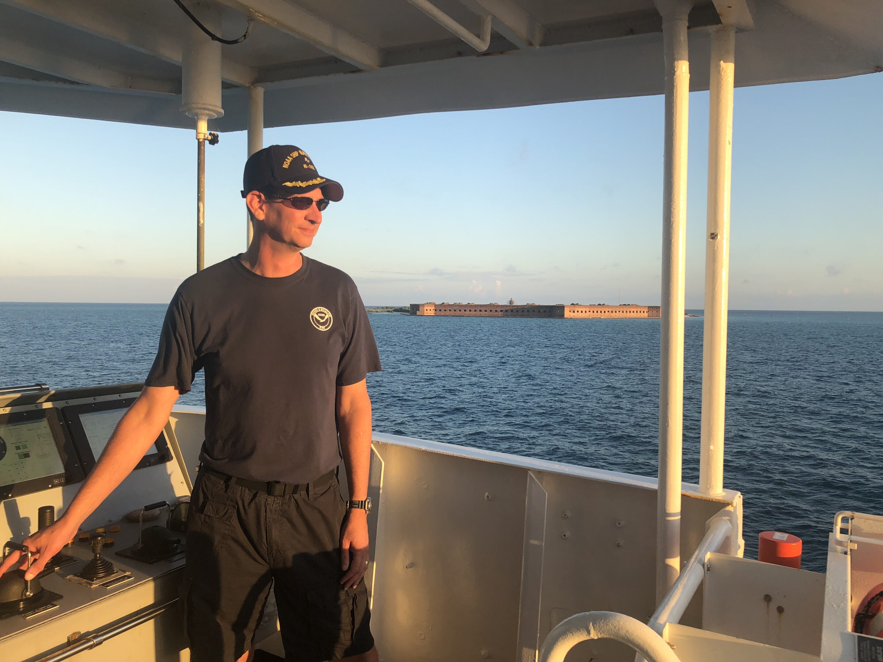 Mark captaining photo of man captaining a vessel